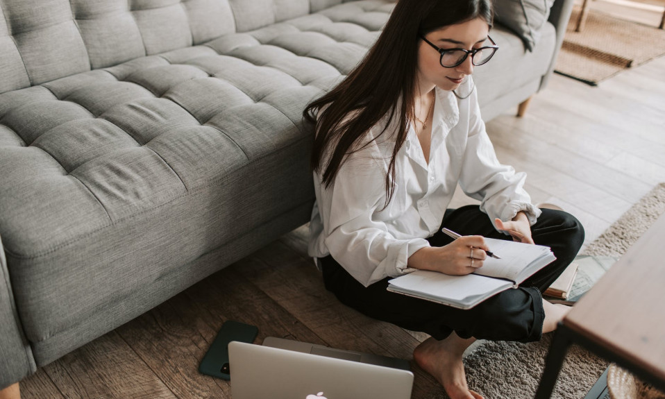 woman writing on notebook